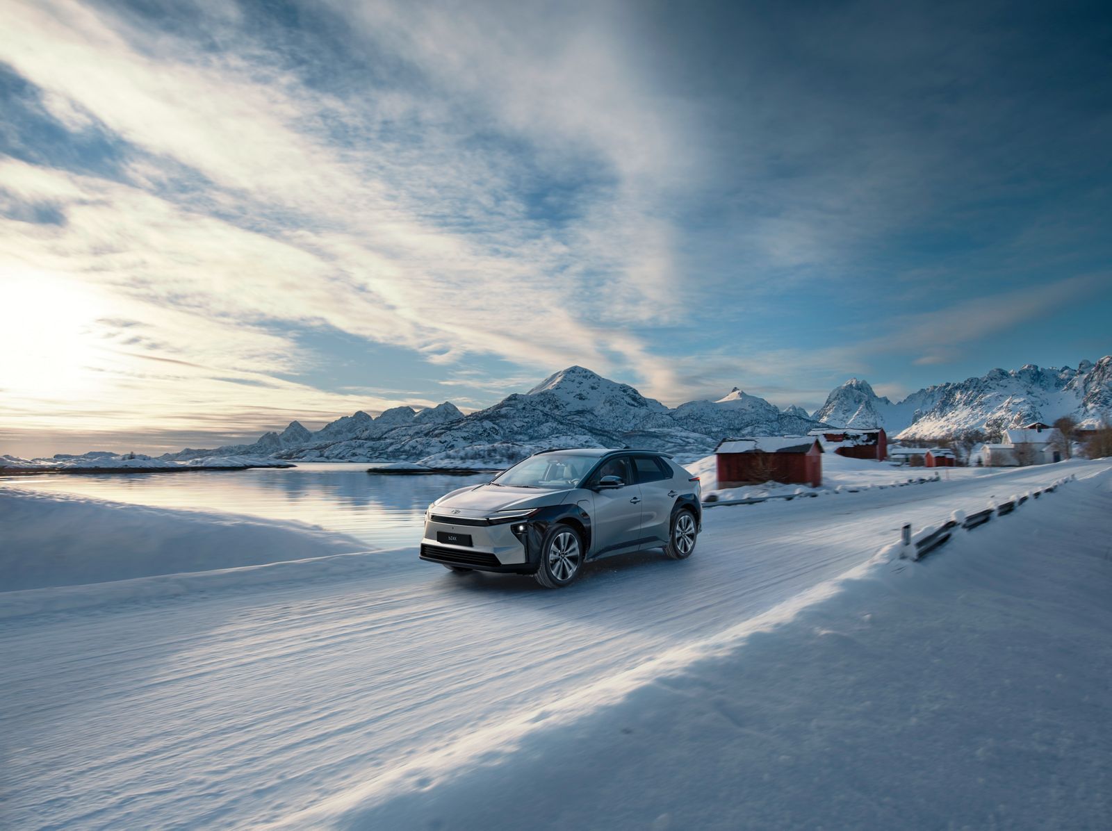 A Toyota bZ drives across a snow-covered landscape 