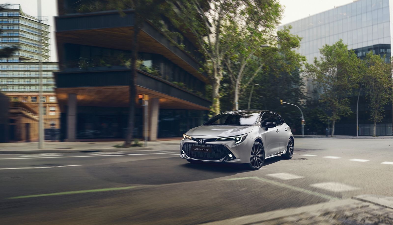  A Toyota Corolla Hatchback drives through city streets 