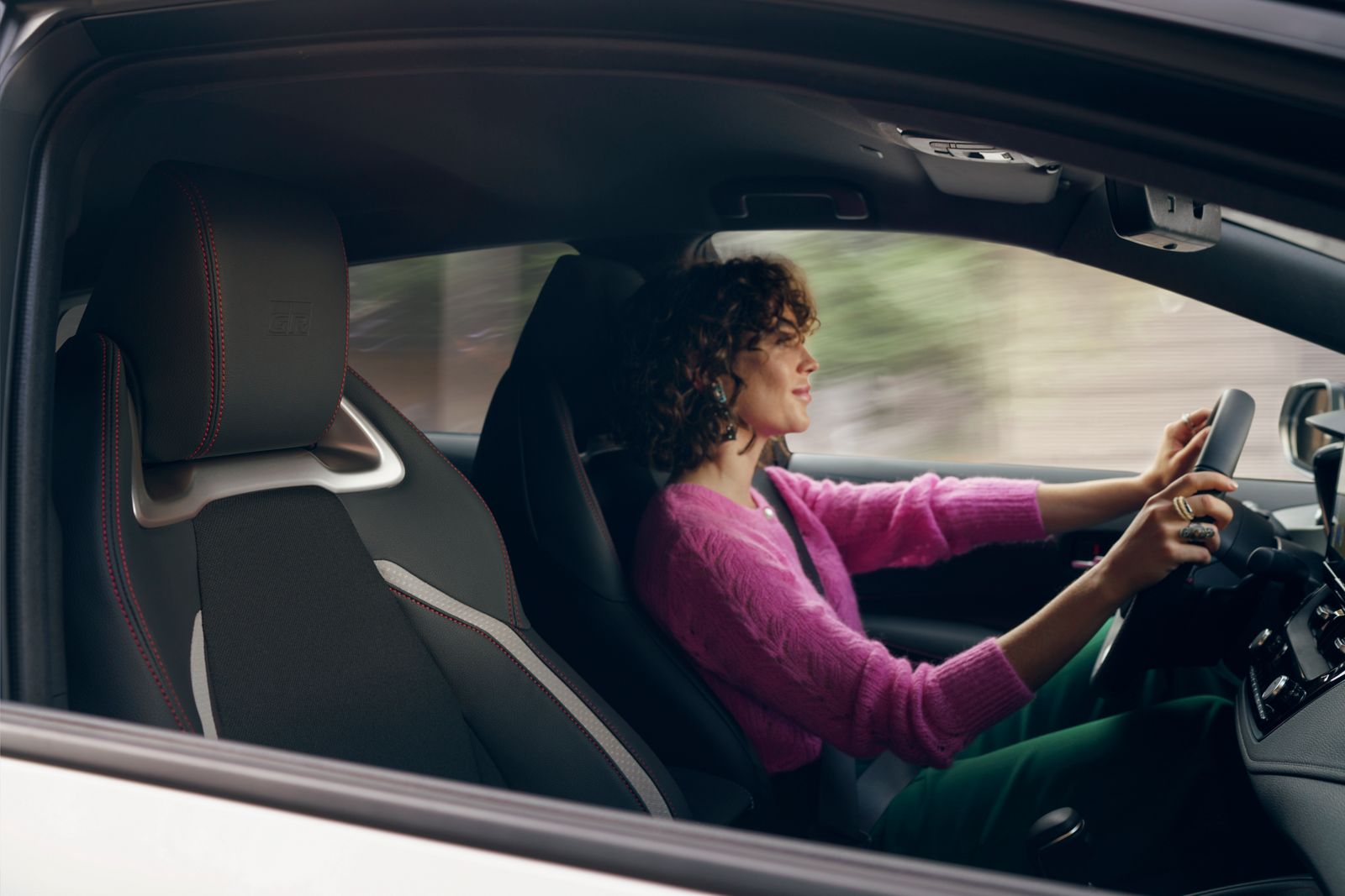 An owner at the wheel of their Toyota Corolla Hatchback