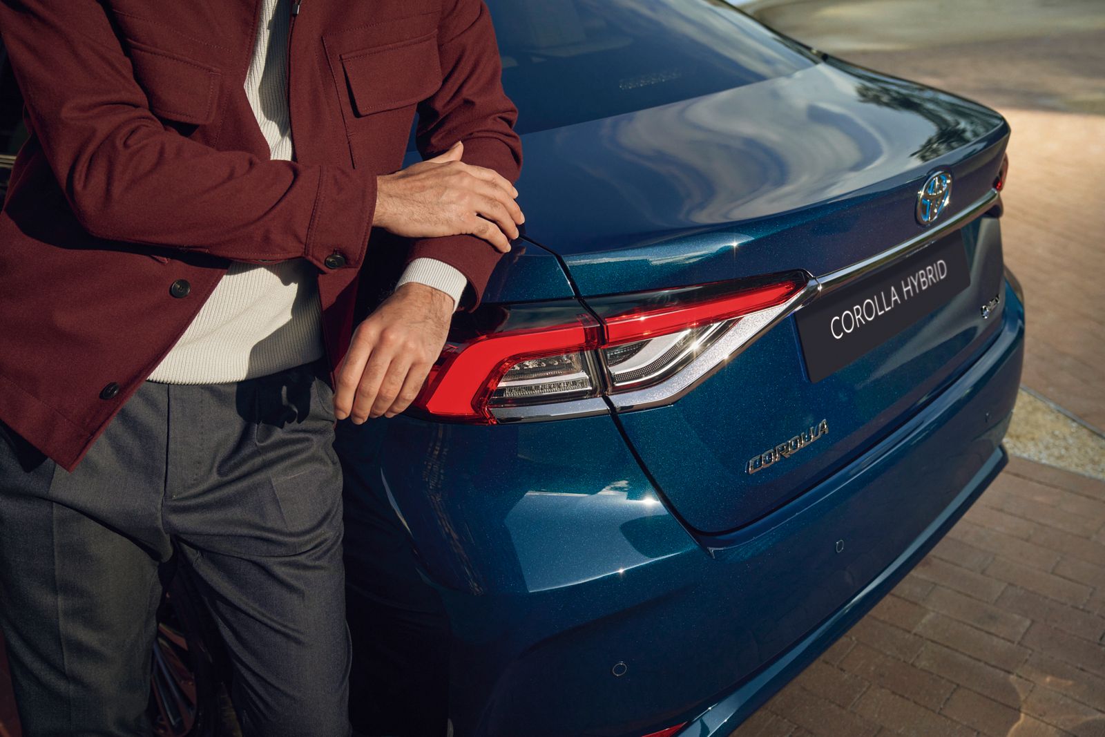 An owner walks past their Toyota Corolla Sedan
